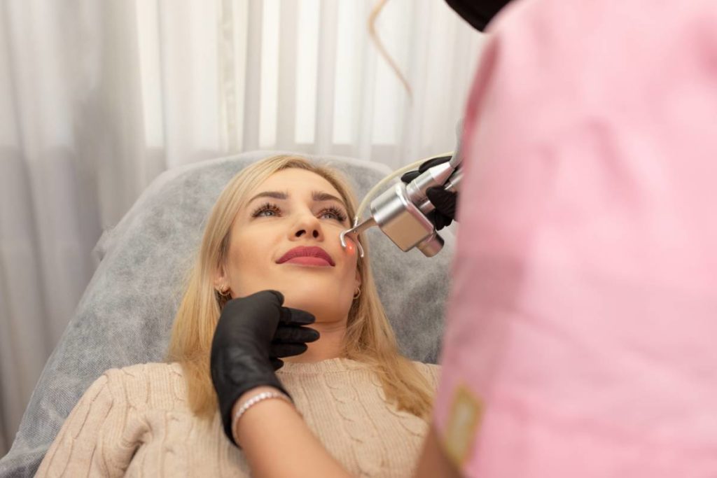 Woman getting cosmetic laser specialist treatment