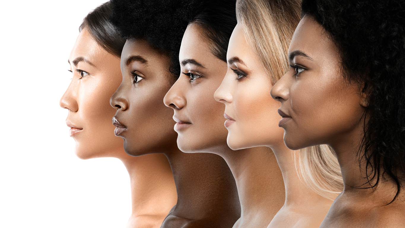 A diverse group of women showcasing various skin tones, celebrating unity and inclusivity in their expressions and poses