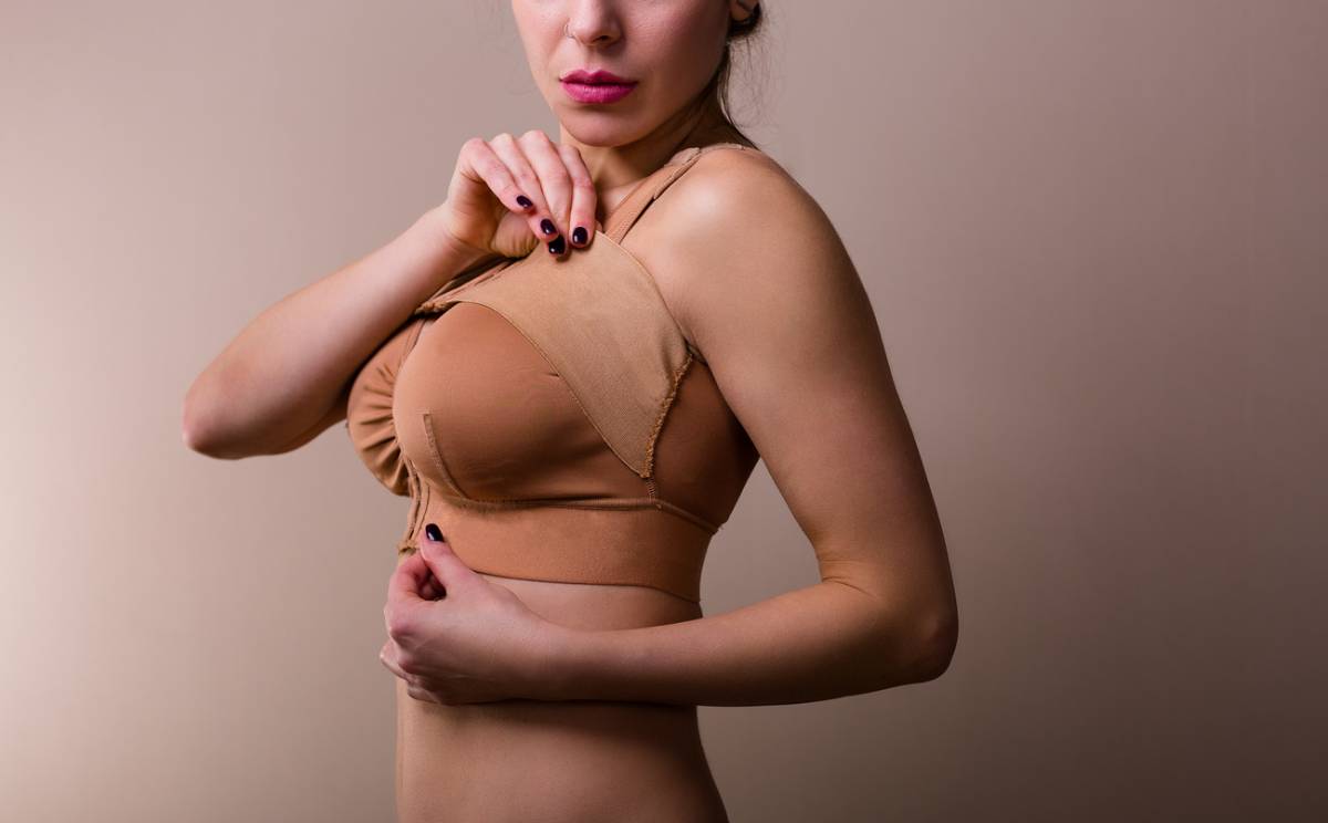 A woman in a bra top confidently poses for the camera, showcasing her style and self-assurance.
