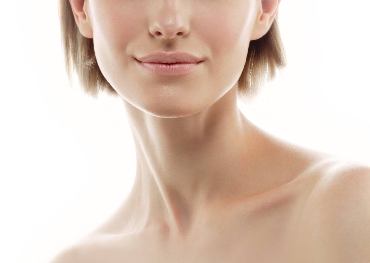A woman with very short hair and a clean face, exuding confidence and simplicity in her appearance.