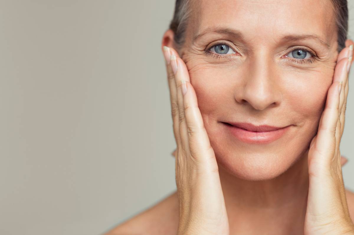 A woman with her hands on her face, expressing a moment of contemplation or surprise.