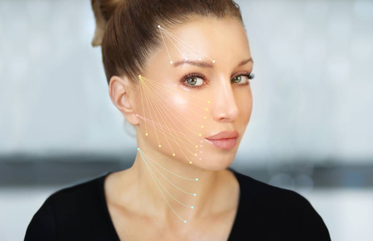 A woman with a series of dots arranged on her face, showcasing a unique and artistic facial design.